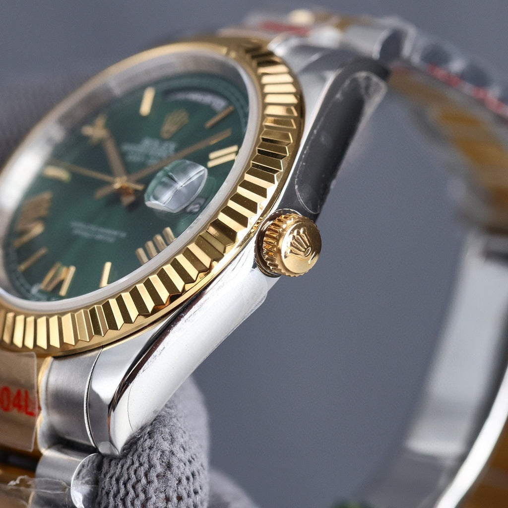 Two-tone Rolex watch with green dial and gold bezel; crown detail on case.