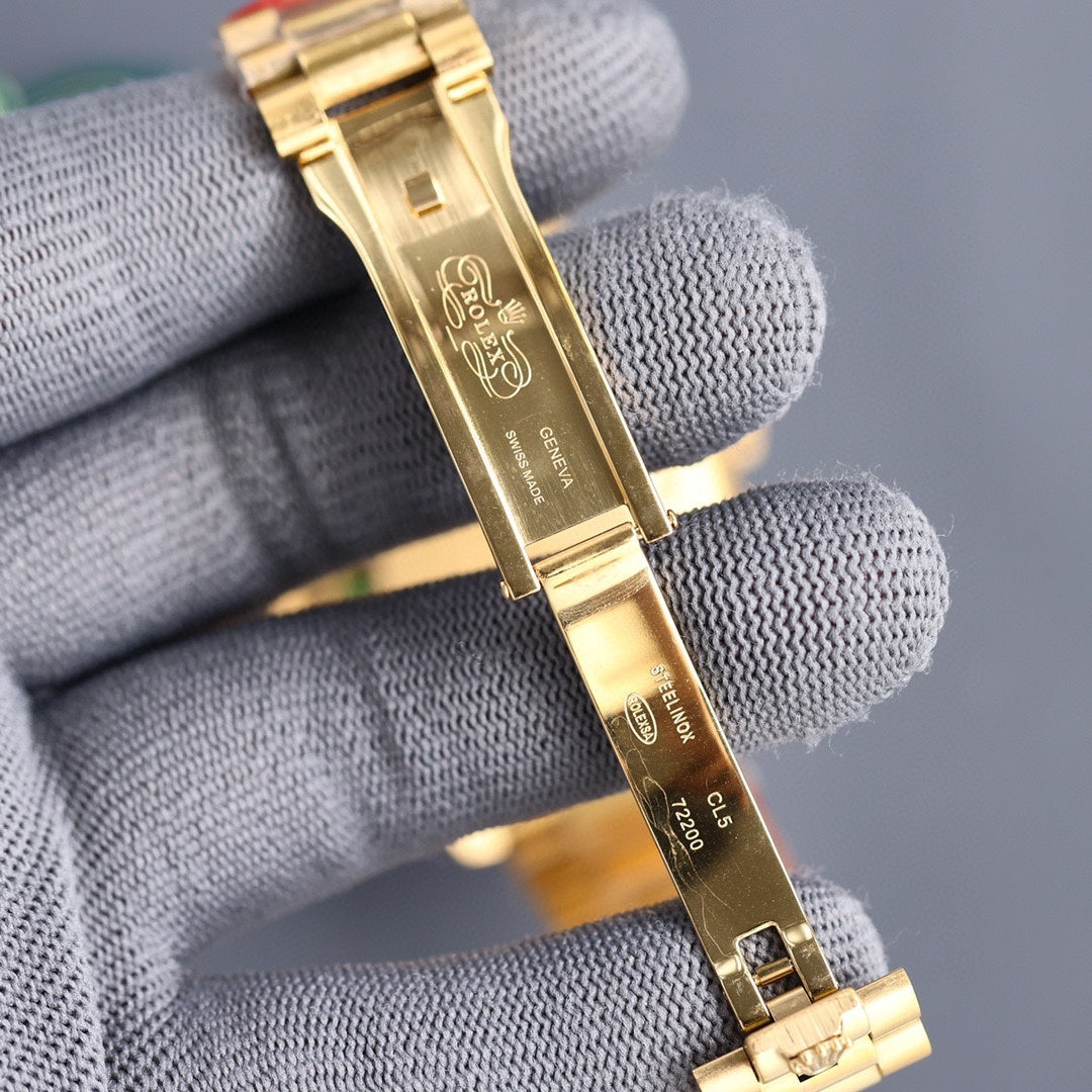 Gold-tone Rolex watch bracelet close-up with clasp and engraved metal links