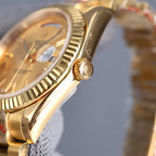 Rolex watch side and crown detail, gold-tone metal
