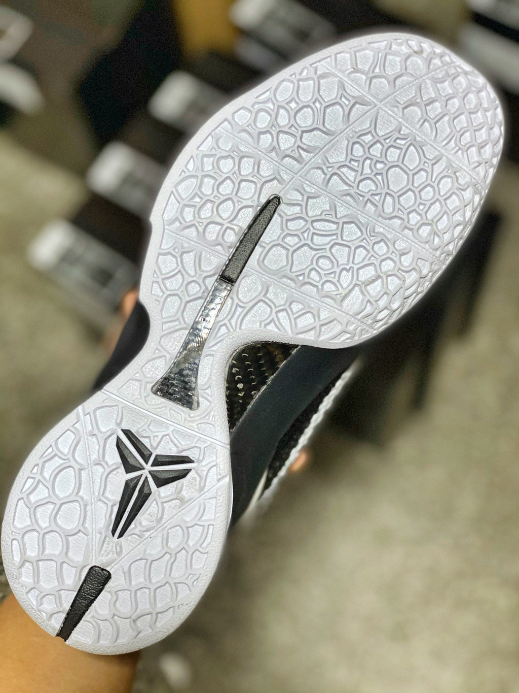 White rubber outsole with black traction pods and star-shaped design, side cutout.