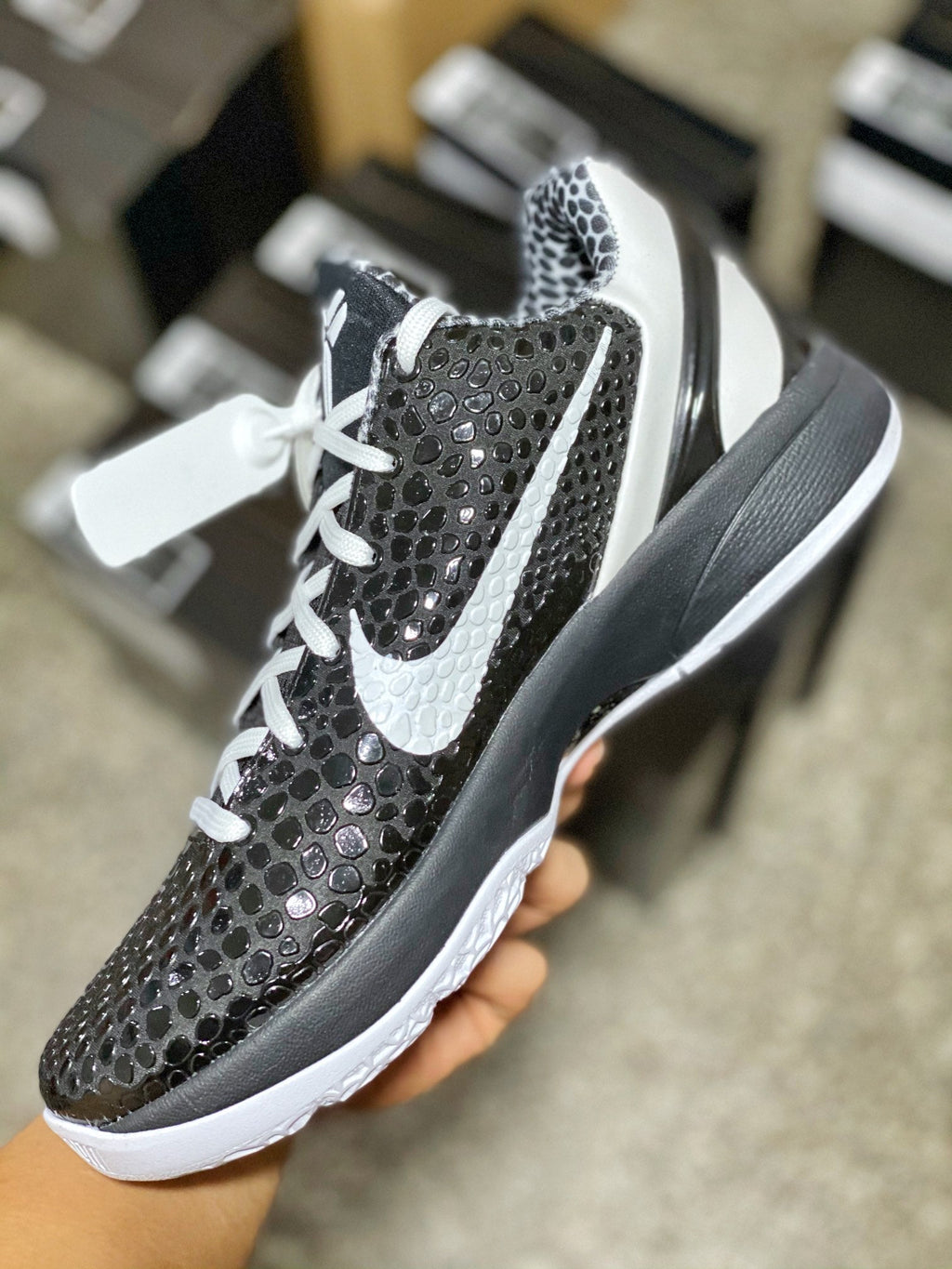 Black and gray mesh low-top sneaker with white laces, Swoosh, and white midsole.