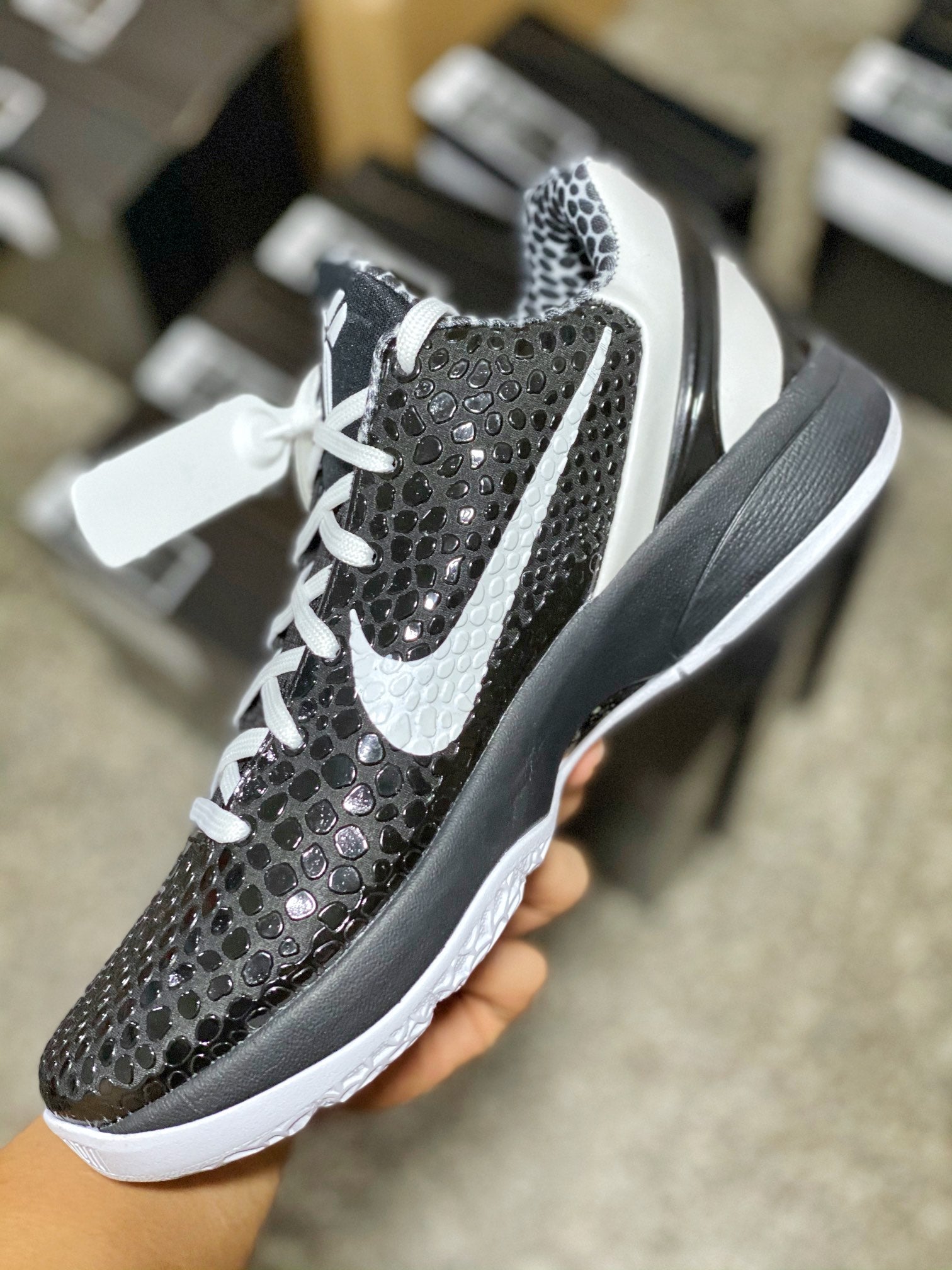 Black and gray mesh low-top sneaker with white laces, Swoosh, and white midsole.