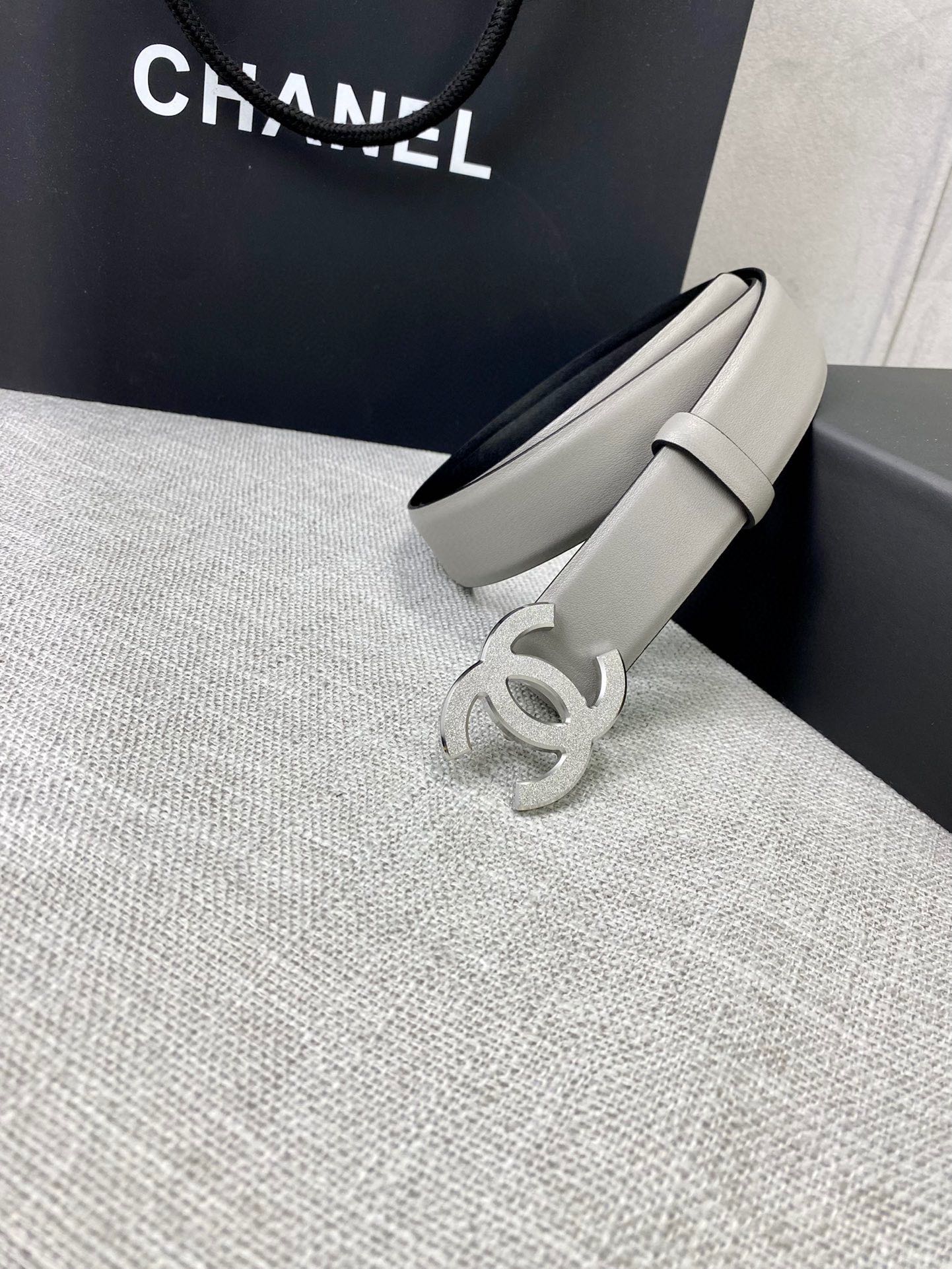 Light gray CC-buckle belt, side view with curved metal logo
