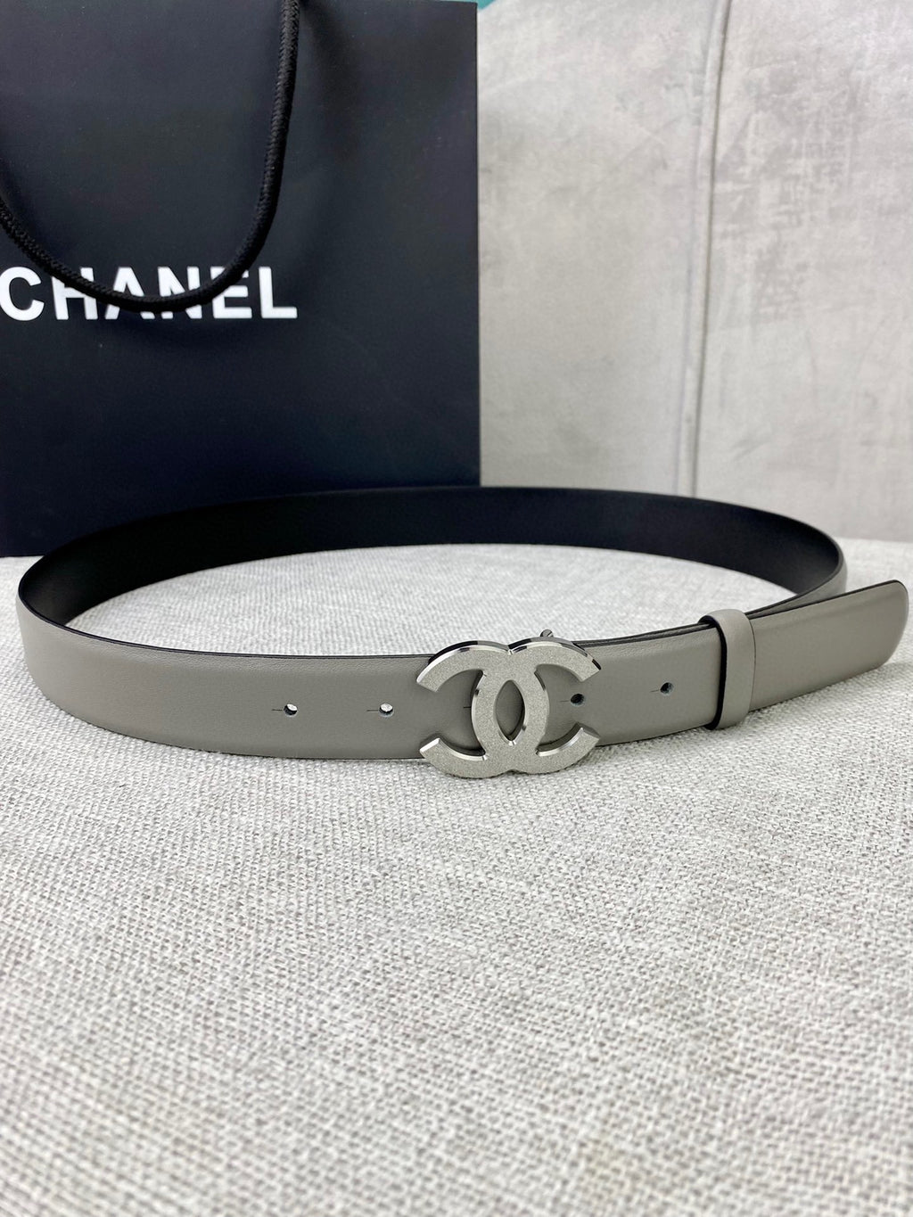 Light gray CC-buckle belt with metal buckle and punched holes