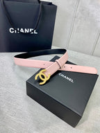 Pale pink leather belt with gold CC logo buckle and adjustable pin holes.