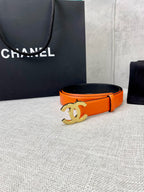 Chanel orange belt with gold CC logo buckle, angled view