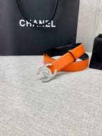 Chanel orange belt with silver-toned CC buckle and black strap