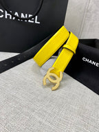 Chanel belt with bright yellow strap and gold CC buckle, coiled on display