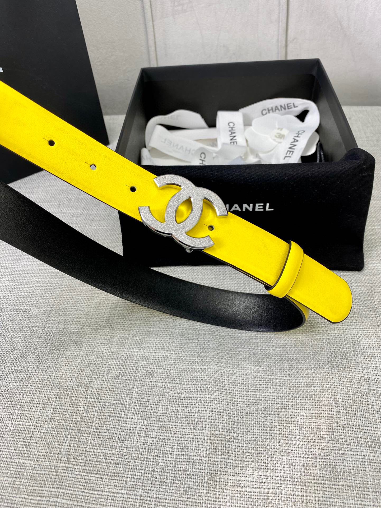 Chanel belt with bright yellow leather strap and gold CC logo buckle on box