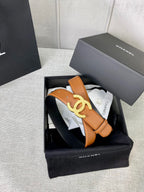 Tan leather belt with gold-tone CC buckle, in open presentation box.