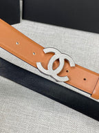 Tan leather belt with gold-tone CC buckle, close-up of buckle and holes.
