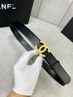 Chanel belt with black leather strap and gold-tone CC logo buckle