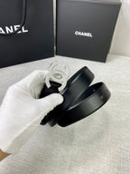 Chanel belt detail with silver-tone CC buckle and black leather strap