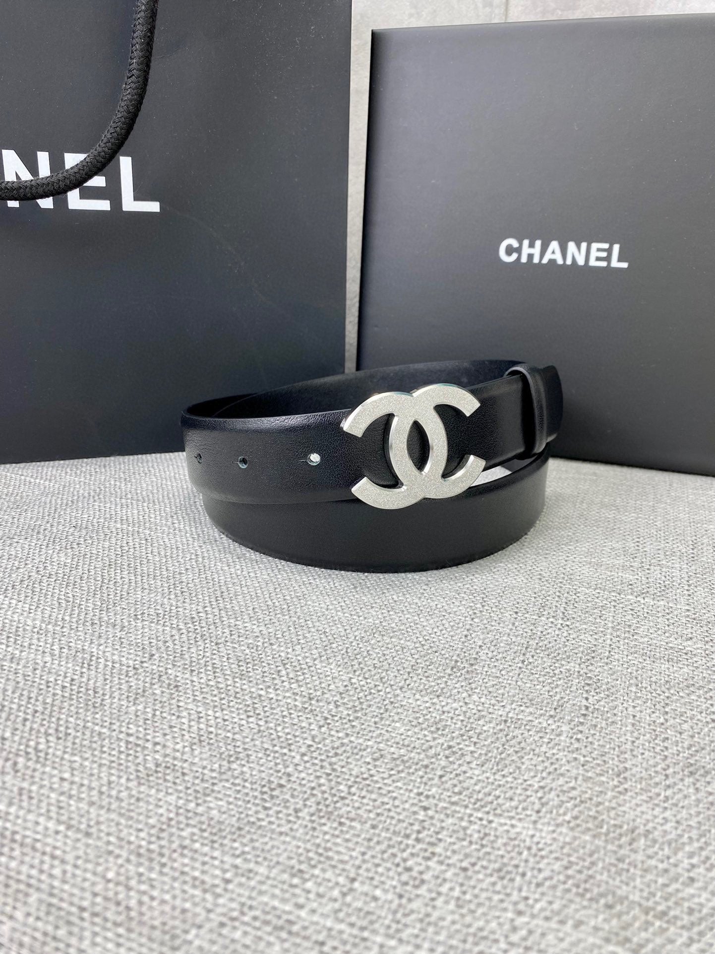 Chanel belt with black leather strap and silver-tone CC logo buckle