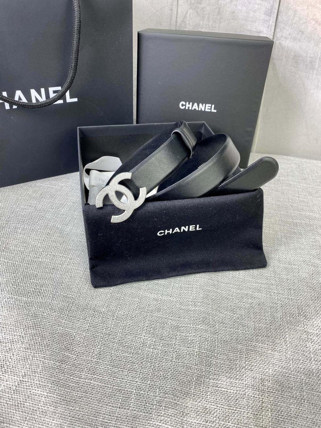 Chanel belt in gift box, black leather strap with silver-tone CC logo buckle