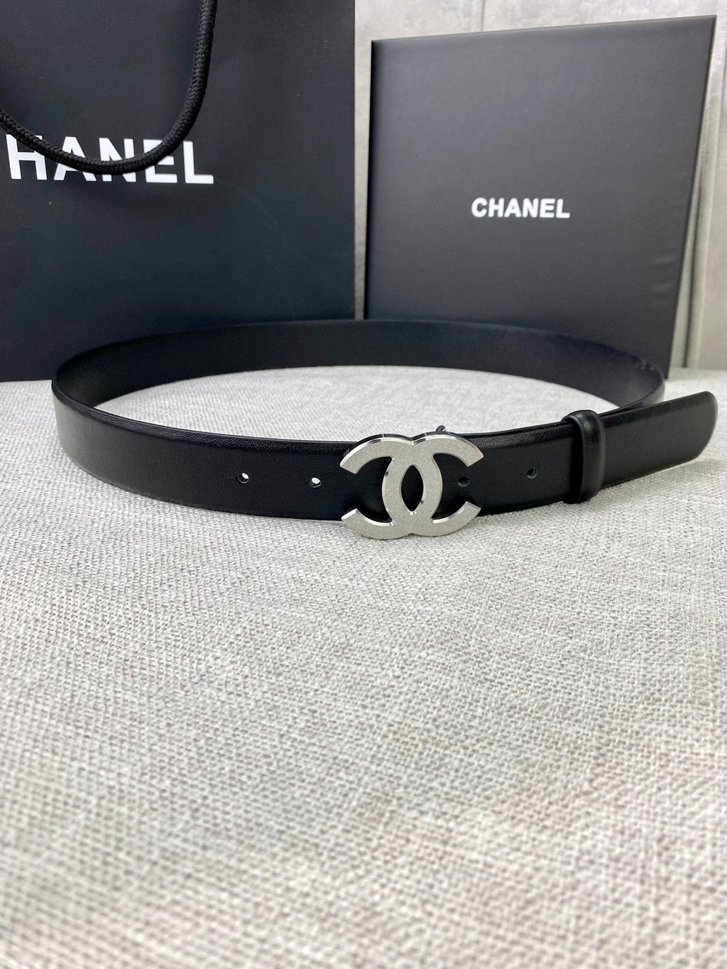 Chanel belt with black leather strap and silver-tone CC logo buckle