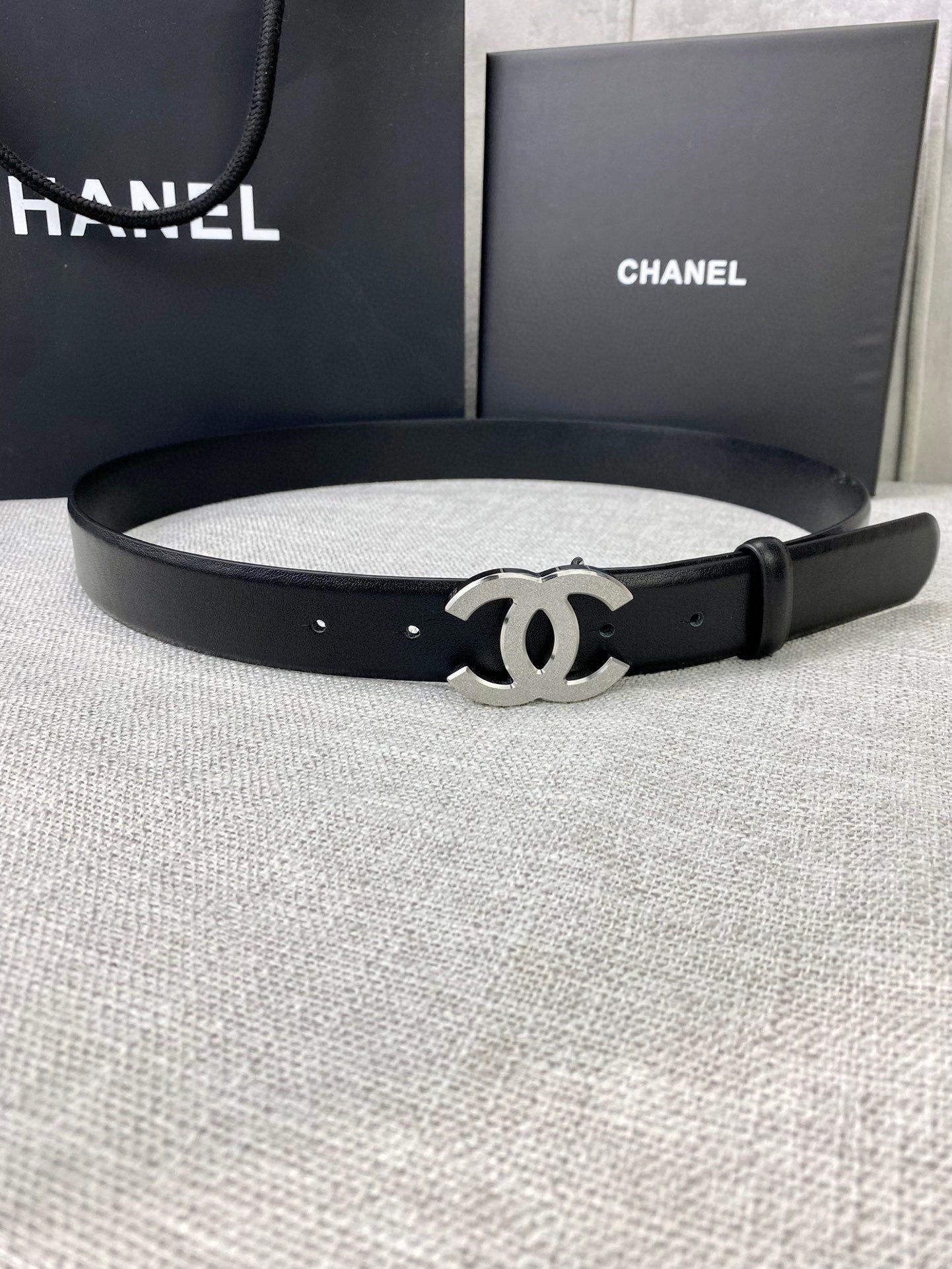 Chanel belt with black leather strap and silver-tone CC logo buckle