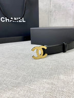 Chanel belt with black leather strap and gold-tone CC logo buckle, close up