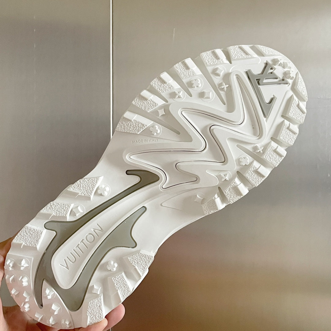 White and gray sneaker outsole with deep tread and molded logo detailing