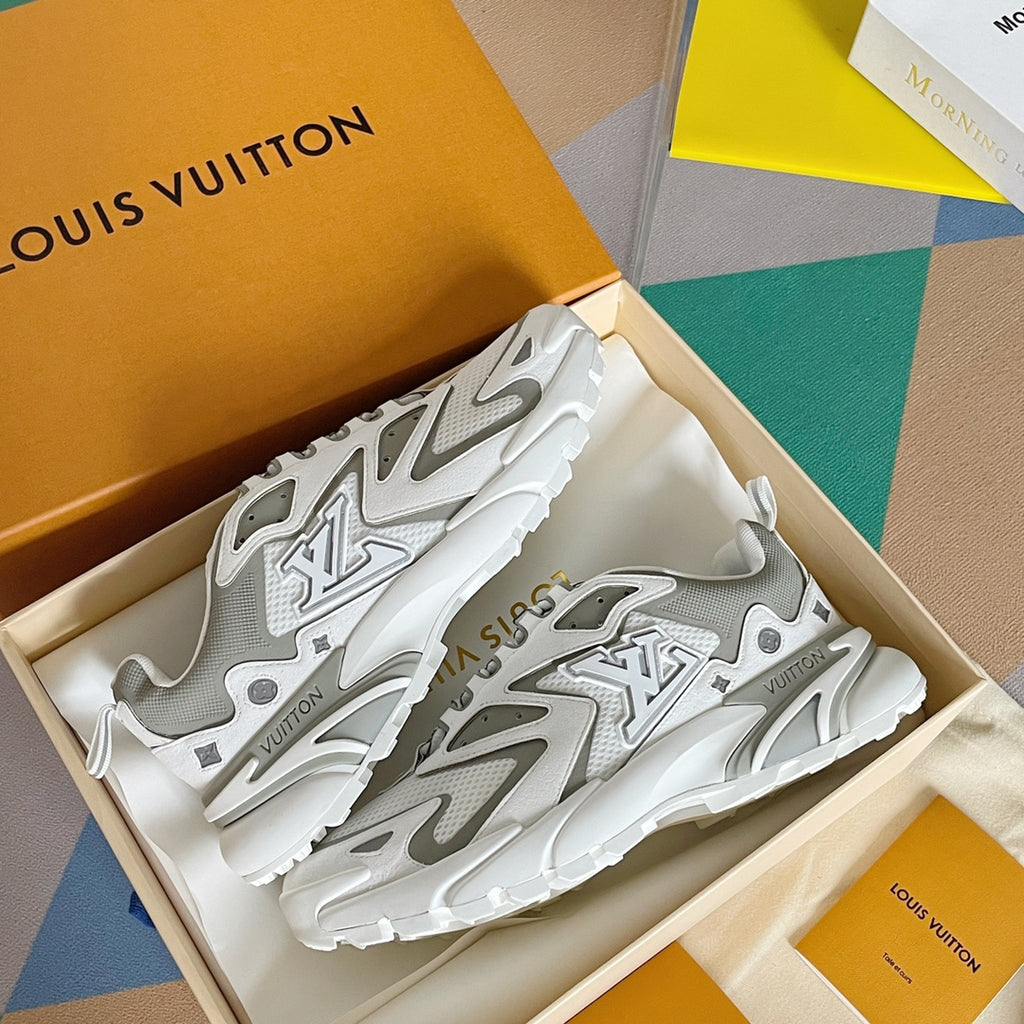 Pair of white and gray sneakers with bold logo graphics and chunky tread outsole