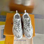 White and gray lace-up sneakers standing side by side with chunky rubber soles