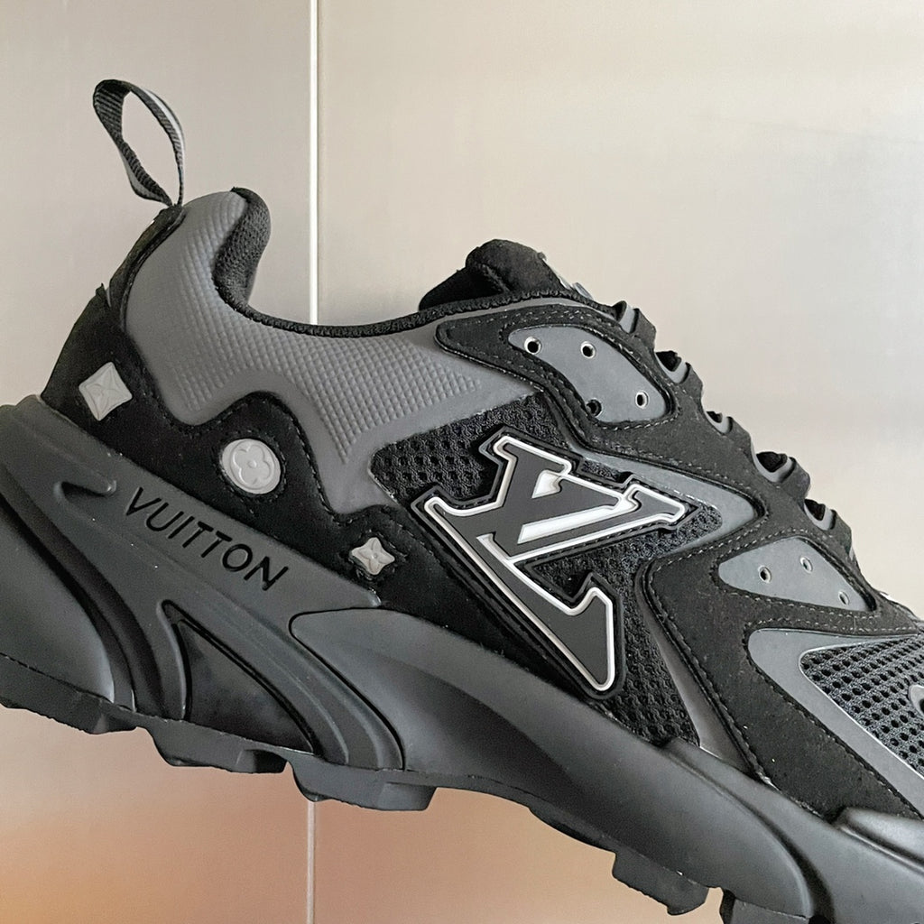 Louis Vuitton unisex sneakers close-up, black/gray with LV emblem and textured sole