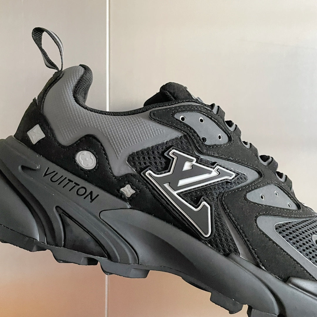Louis Vuitton unisex sneakers close-up, black/gray with LV emblem and textured sole