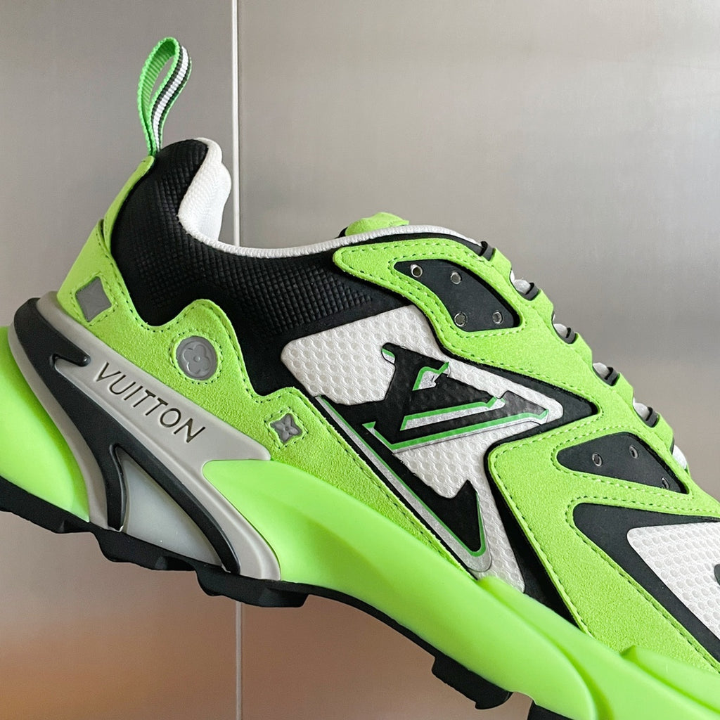 Close-up Louis Vuitton sneaker with neon green, white, and black panels and textured sporty trim