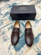 Prada unisex leather loafers with metal buckle strap, dark brown, front view pair