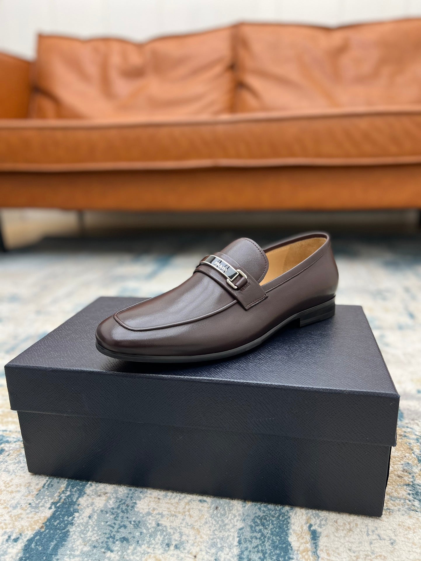 Prada unisex leather loafer with metal buckle strap, dark brown, on box