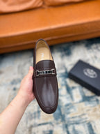 Prada unisex leather loafer with metal buckle strap, dark brown, held up front view