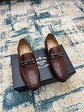 Brown Prada leather loafers with silver buckle strap, unisex slip-on style