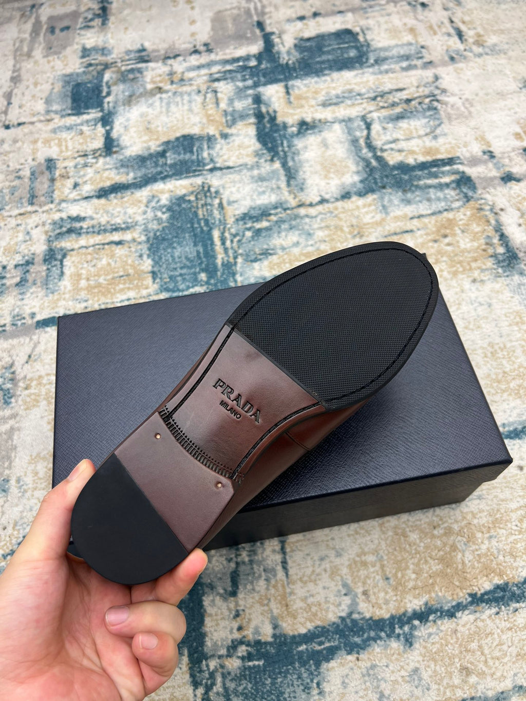 Prada unisex leather loafer, brown upper with black sole, bottom view