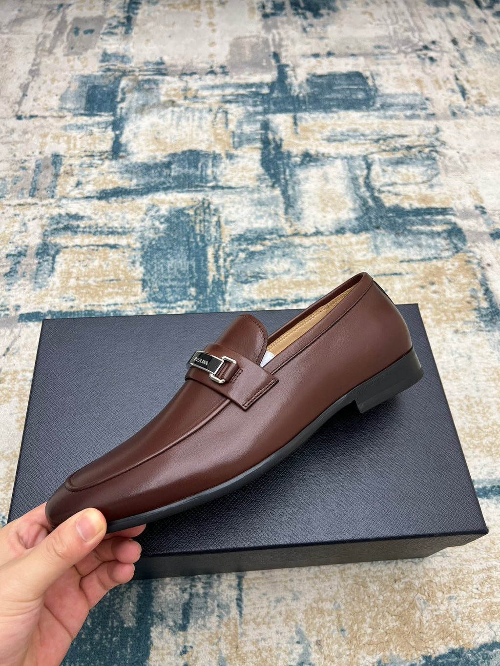 Prada unisex leather loafer, brown with silver buckle strap, side profile