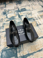 Prada black leather loafer shoes with metal buckle strap, glossy finish