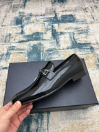 Prada unisex polished black loafer with buckle strap, side profile