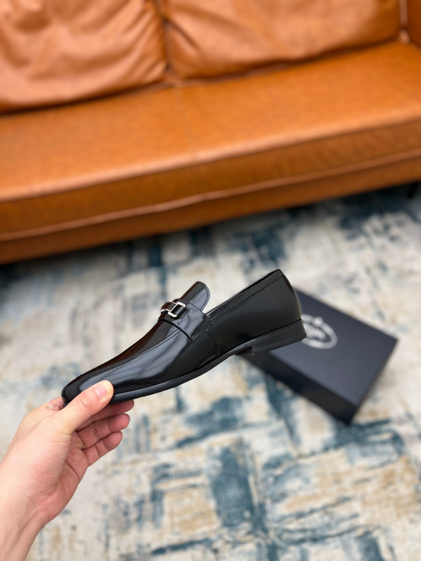 Prada black leather loafer with buckle strap, side view and shoe box