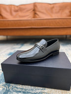 Prada black leather loafer with silver buckle strap, low stacked heel