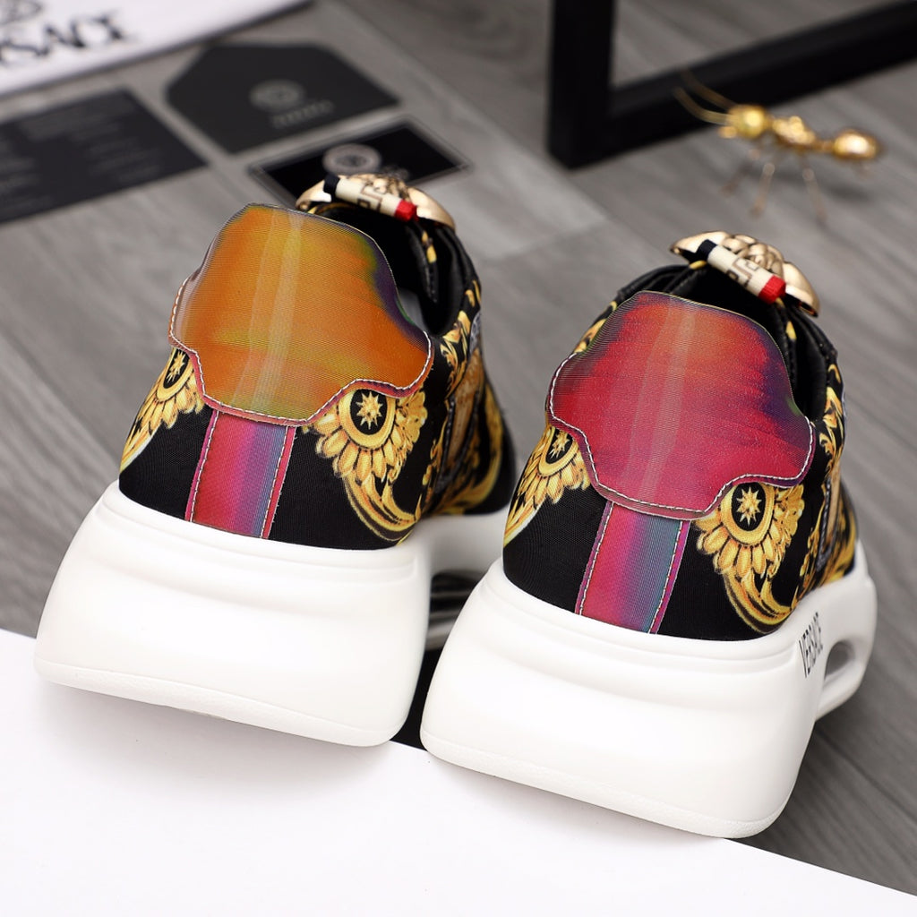 Back view of black sneakers with gold embroidery and rainbow heel panels, white platform sole.