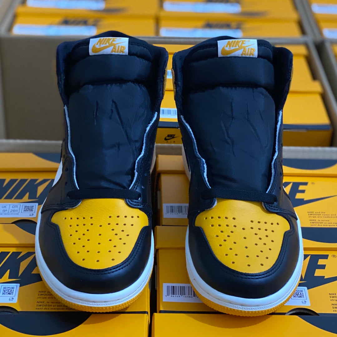 Pair of high-top sneakers rear view in dark blue with yellow toe caps and white soles