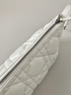 White quilted Dior bag with long top zipper and diagonal panel seams