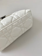White quilted bag end panel with stitched diamond pattern and curved edge.