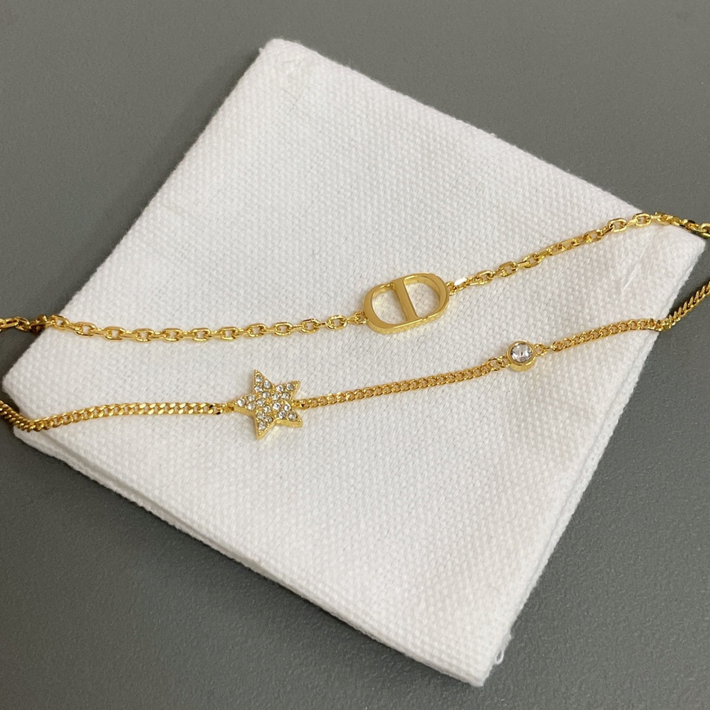 Dior gold-tone bracelet with star charm and oval letter link detail