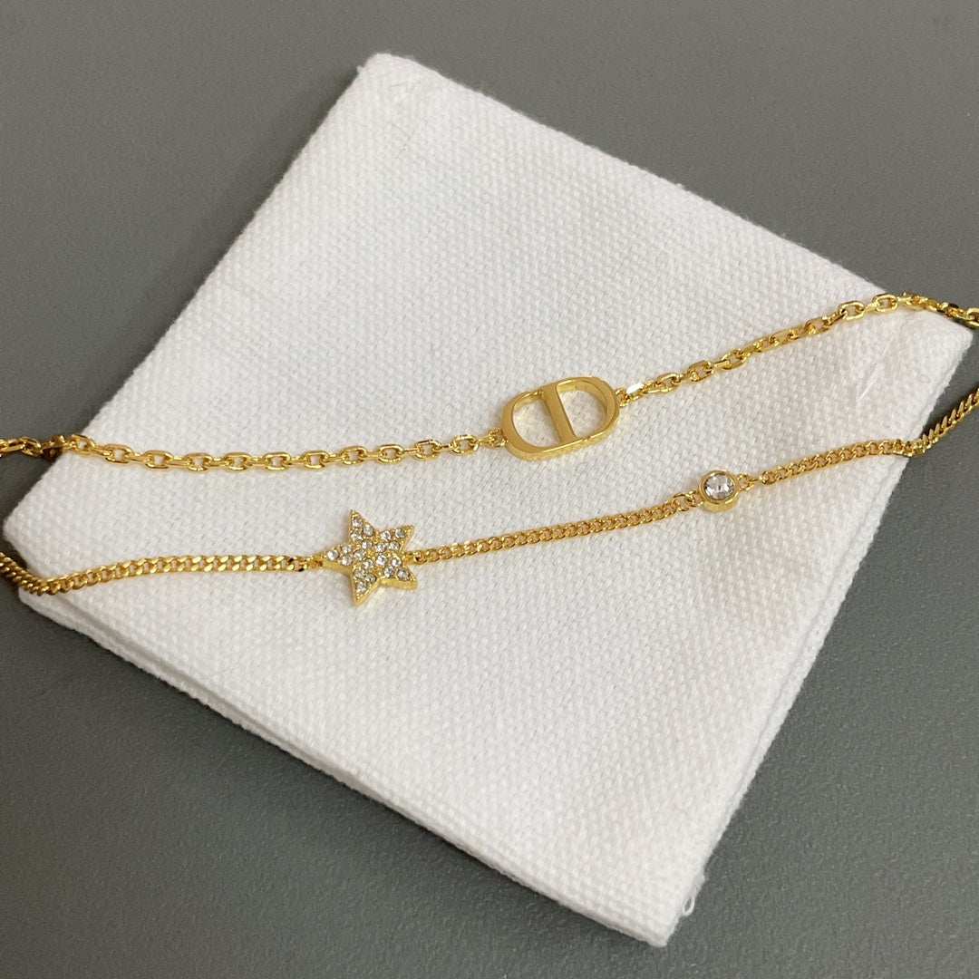 Dior gold-tone bracelet with star charm and oval letter link detail