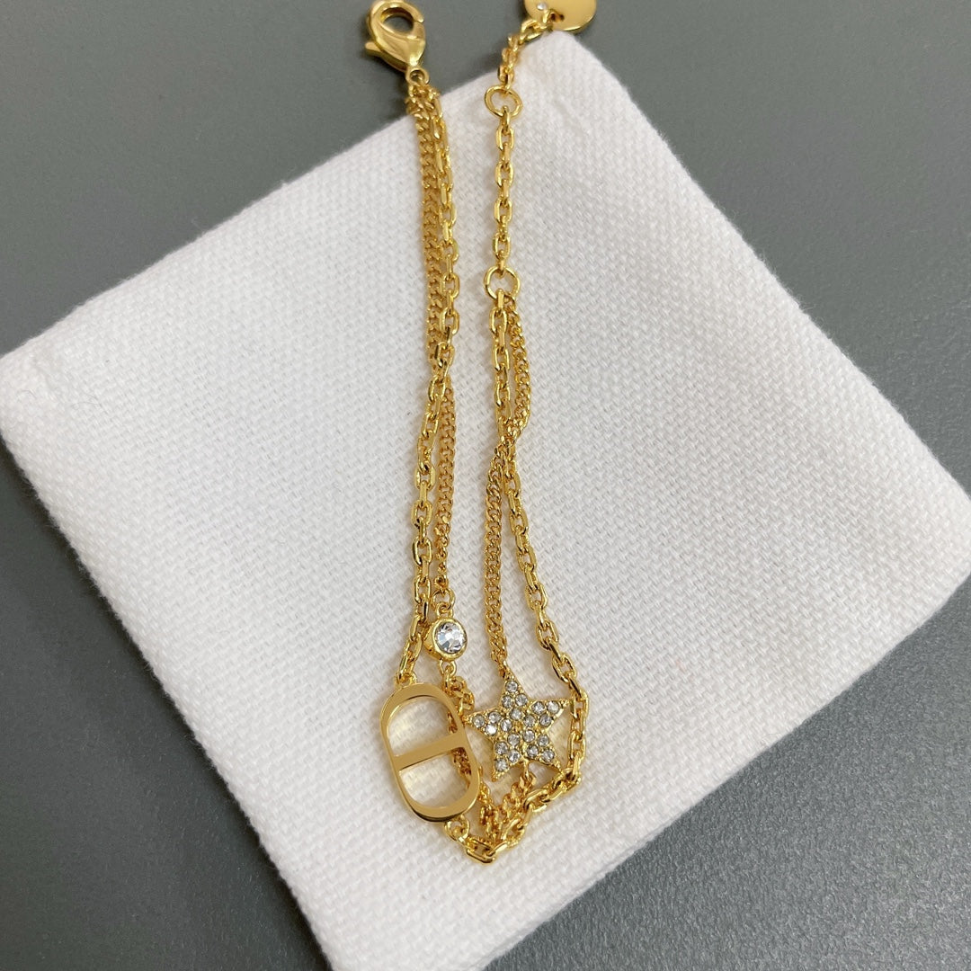 Dior gold-tone charm necklace with oval pendant and dangling round stones