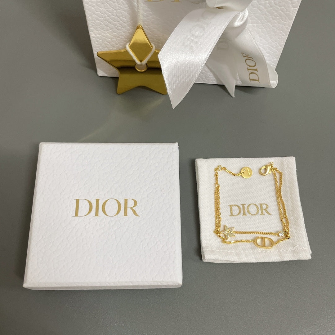 Dior gold-tone star charm bracelet on a fabric pouch and gift box