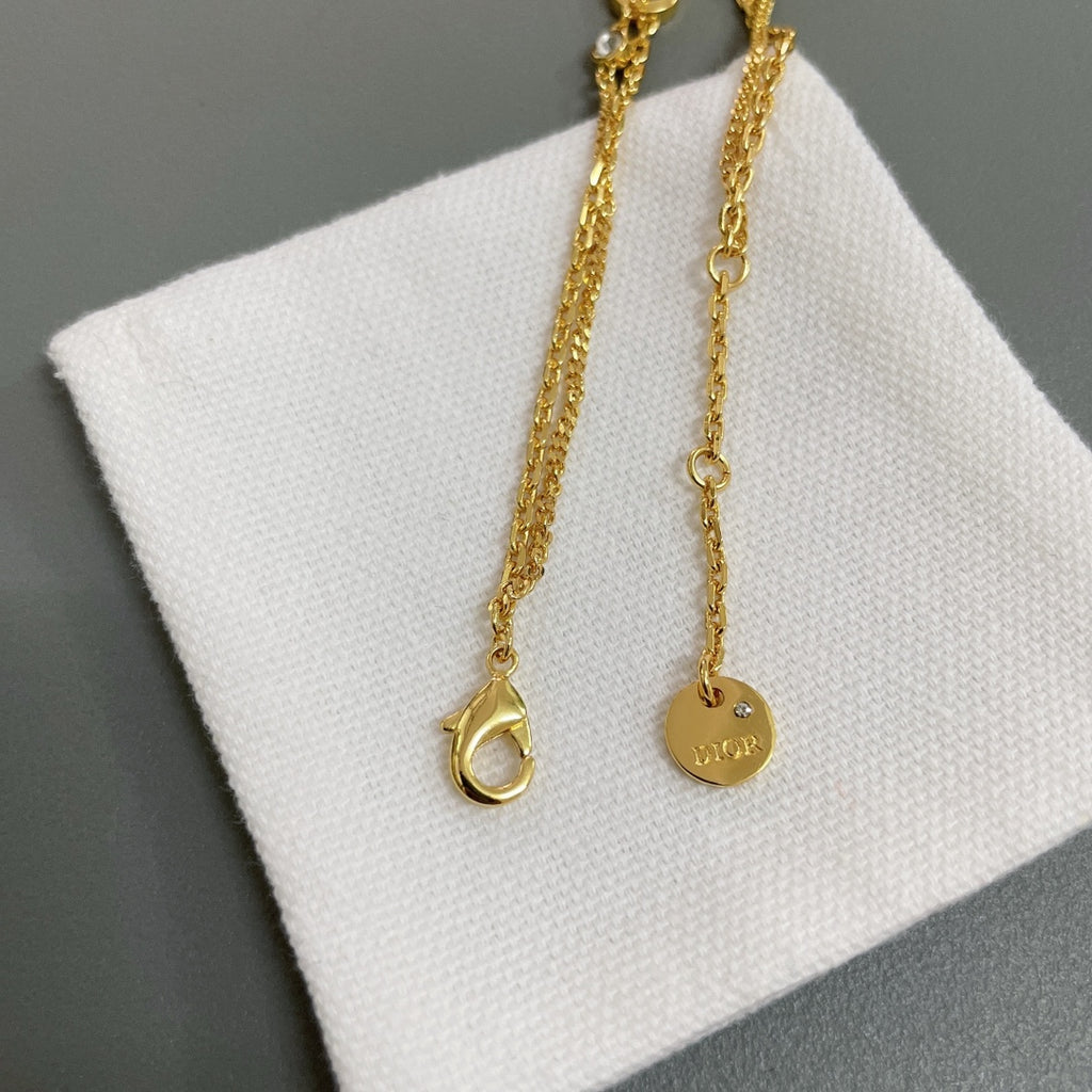 Dior gold-tone charm necklace set with heart-shaped and circular pendants