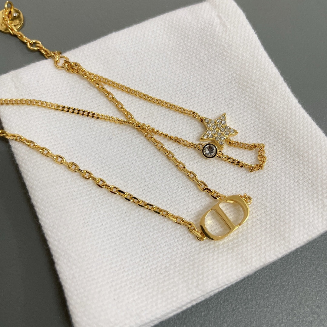 Dior gold-tone layered charm necklace with star, key, and oval pendants