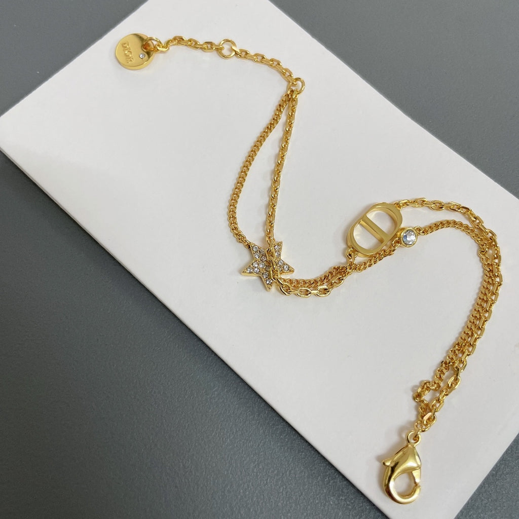 Dior gold-tone charm necklace with oval letter charm and star accents
