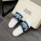 White slide sandals with navy logo strap, close side-by-side view